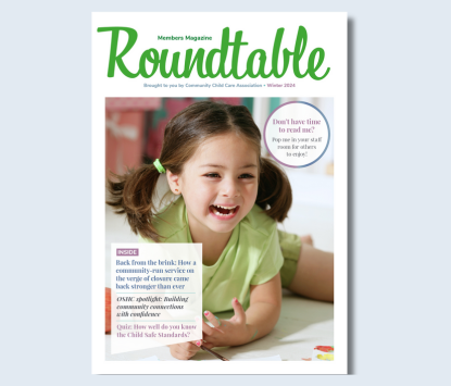 Roundtable magazine cover with preschool-aged child lying on the floor, laughing while painting