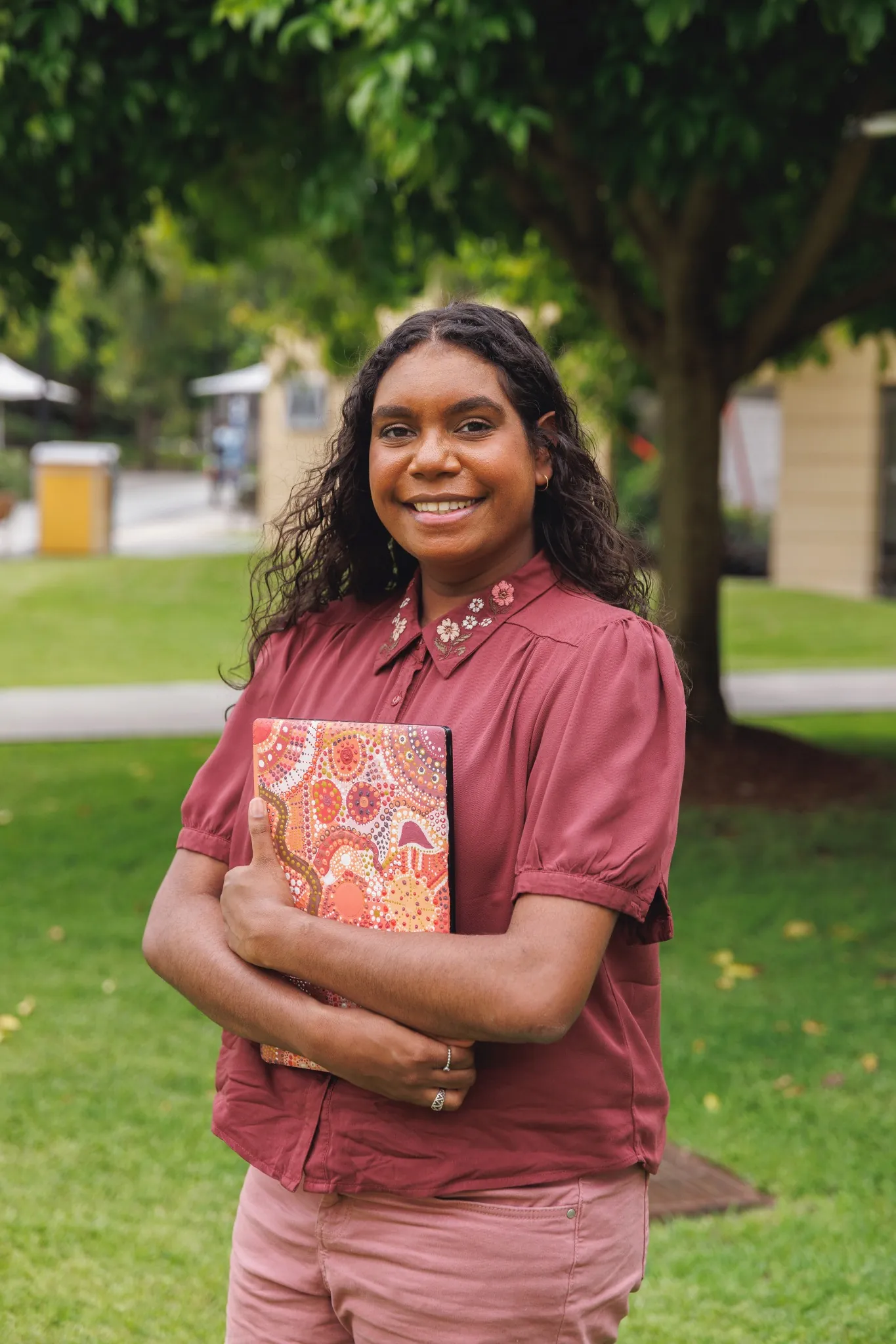 Female Aboriginal Australian Student Holding Laptop She Designed And Painted Herself