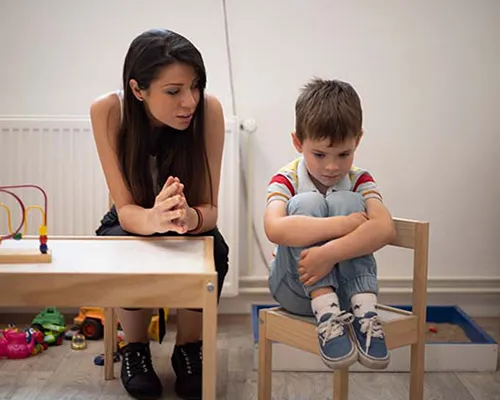 Teacher talking to upset child