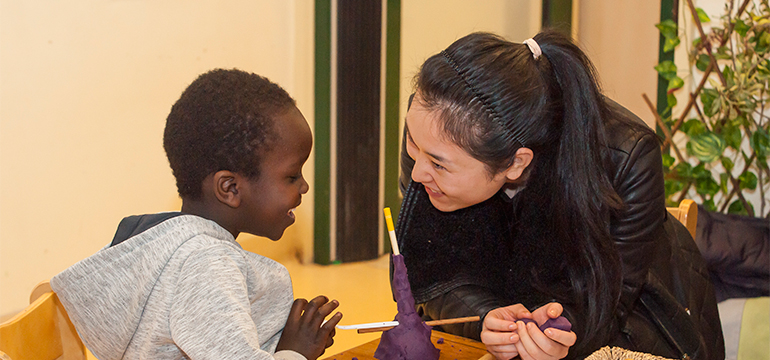 Teacher and young child doing an activity