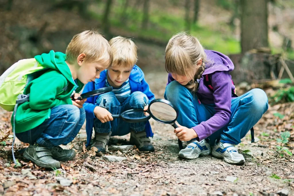 Kids with magnifying glasses exploring the nature