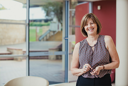 Educator standing at the doors of an education and care setting