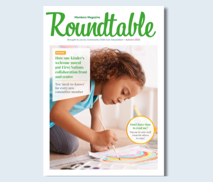 Roundtable magazine cover with a child painting a rainbow on paper on the floor