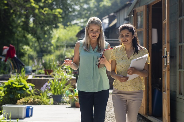 Educational leader walking through garden with educator