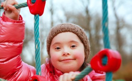 Child climbing on a rope climb