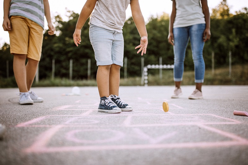 Children playing hopscotch in the school yard