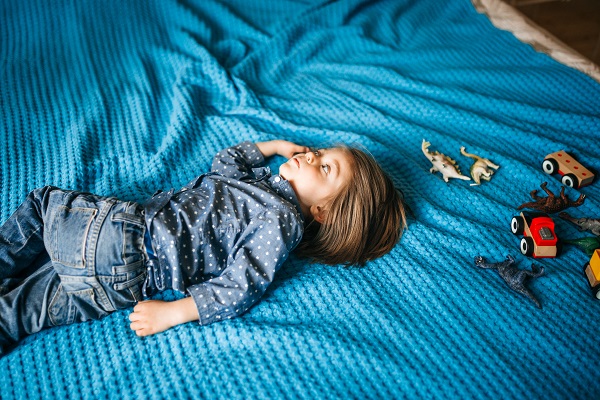 Child sleeping on their bed