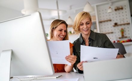 Service leaders looking at documents together smiling