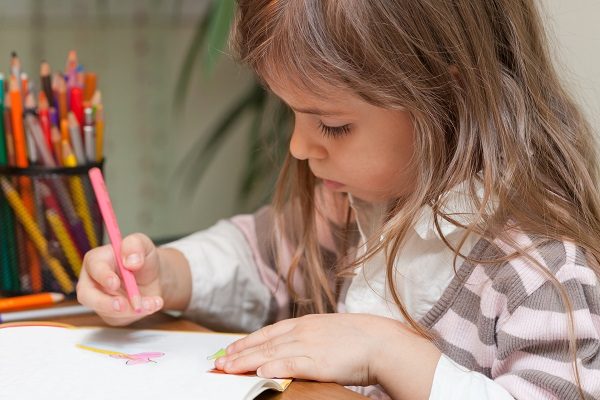 Young child drawing on paper