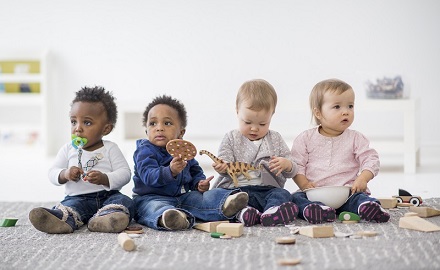 Four children sitting in a row