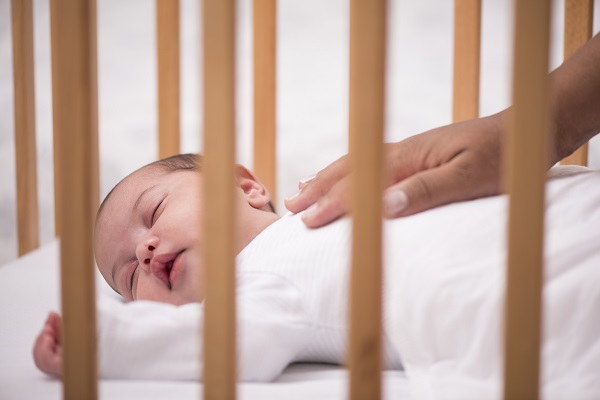 Baby sleeping in a cot