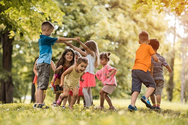 Large group of children playing together in a park