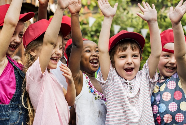 Joyful children raising their hands in the air