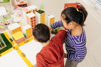 Children creating cardboard model cities